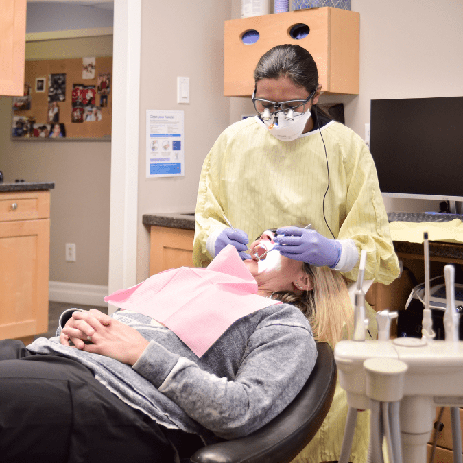 Dr R Kaur Performing Orthodontist Braces on a Patient